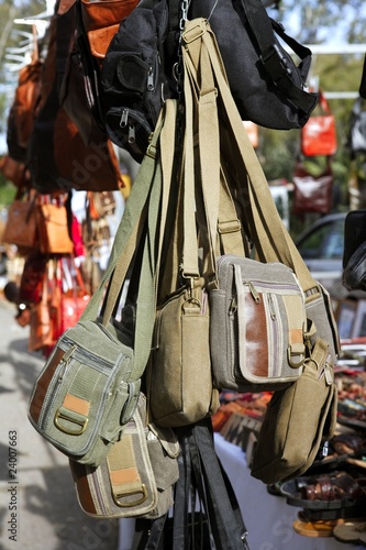 bags hanging in market shop green khaki brown © lunamarina