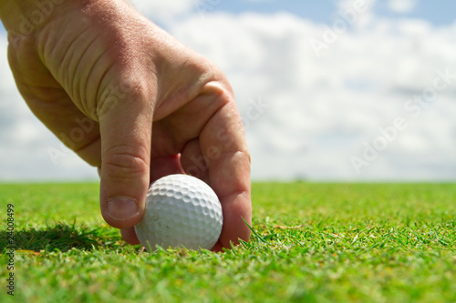 Taking golf ball from the hole