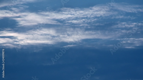 Time lapse clip of white fluffy clouds over blue sky