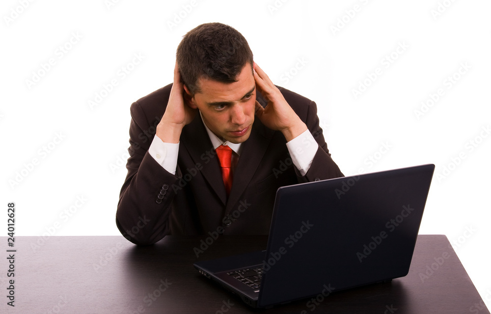 Frustrated business man on a table whith a laptop Frustrated business man on a table whith a laptop