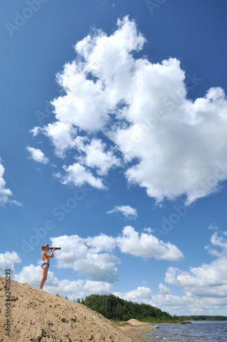 young explorer looks through binoculars