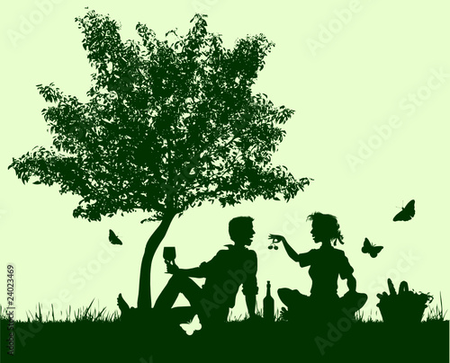 couple picnicunder a young tree photo