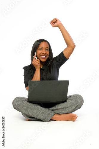 Young African American woman  with computer  and cell phone. © luftaway