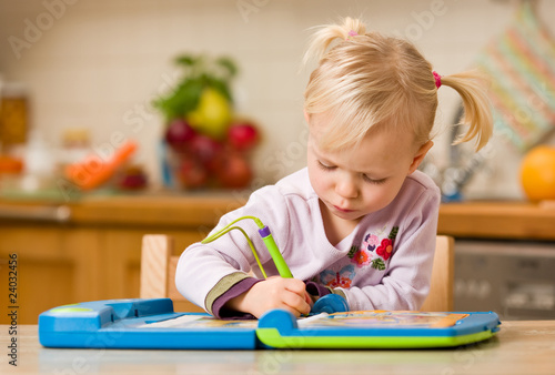 girl playing with toy computer