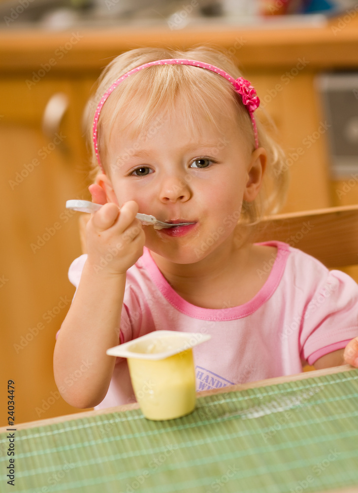 little girl eating yoghurt little girl eating yoghurt