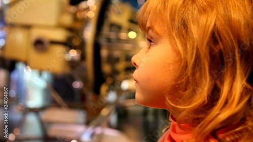girl in space museum, listening  and watching the exhibit