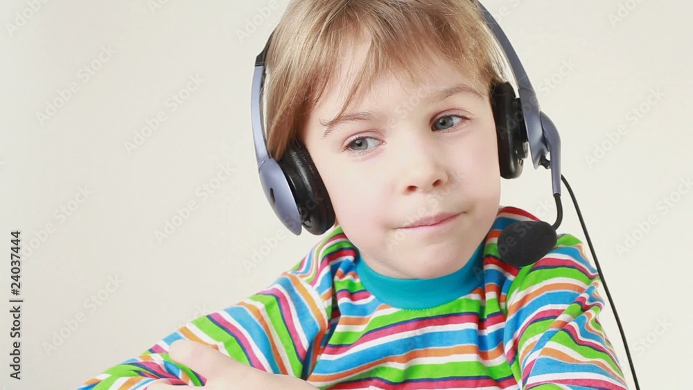 Girl in headset swings from side to side, shakes head and sings