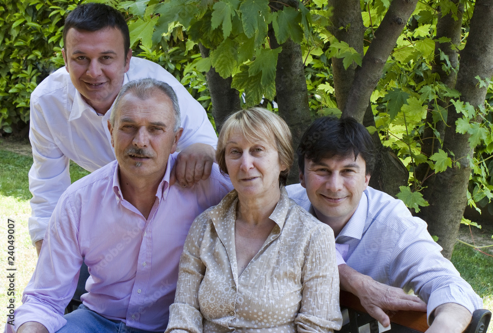 Parents and Sons posing for Family Portrait in the Garden Parents and Sons posing for Family Portrait in the Garden