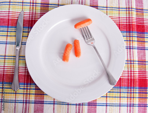 Carrots on White Plate with Fork and Knife