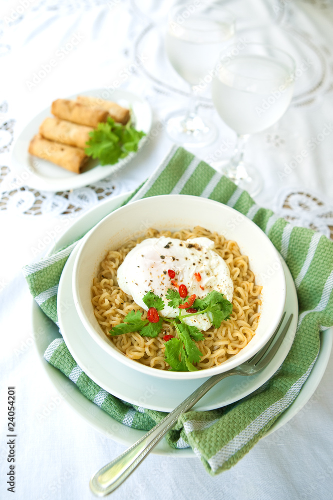 Bowl of spicy oriental noodles with poached egg Bowl of spicy oriental noodles with poached egg