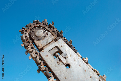 Foto Trench digger over blue sky