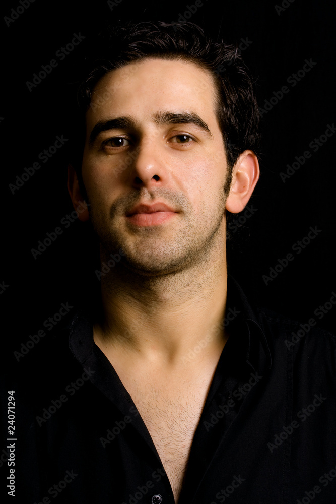 Portrait of young attractive man on a black background