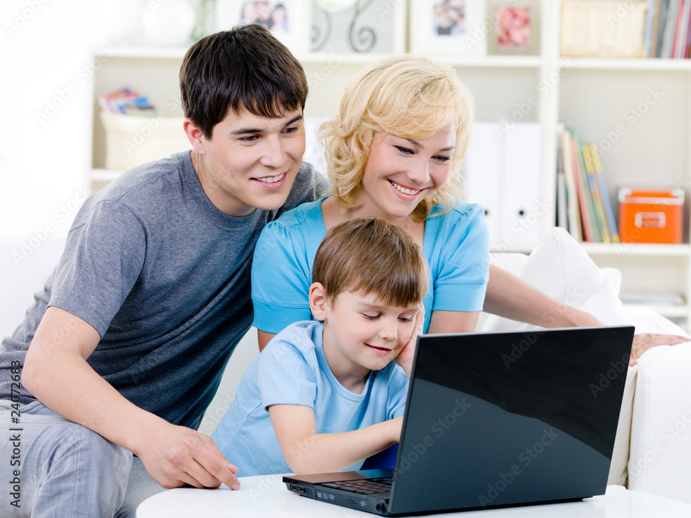 Happy family using laptop at home Happy family using laptop at home