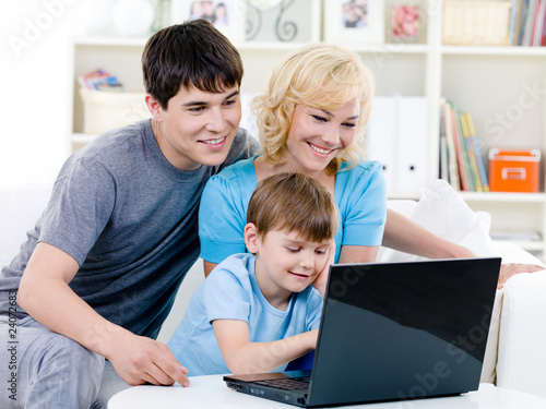 Happy family using laptop at home