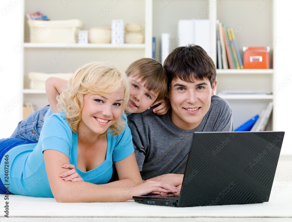 Smiling family using laptop Smiling family using laptop