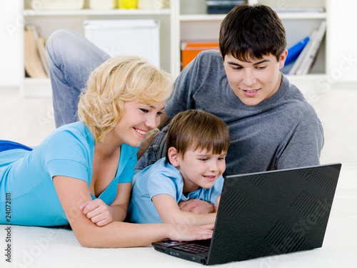 Happy family looking in laptop together