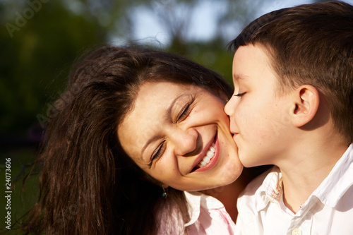 little boy kiss his mother