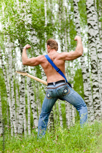 muscular man with electric guitar