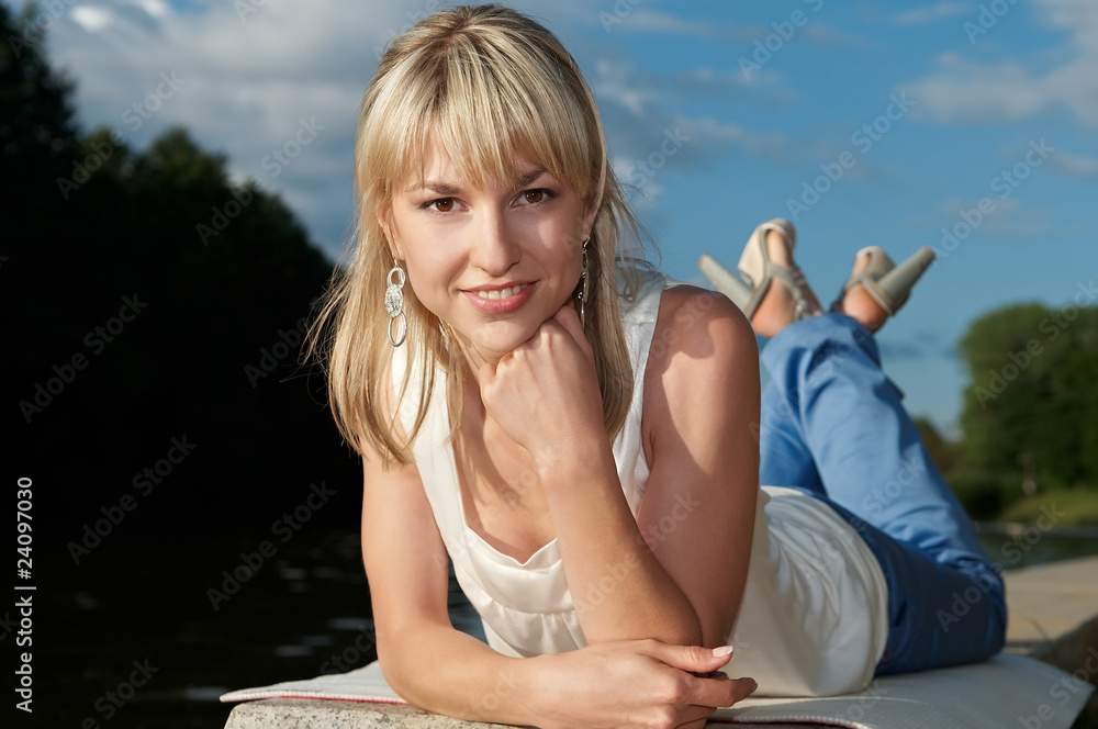 smiley lying woman outdoors