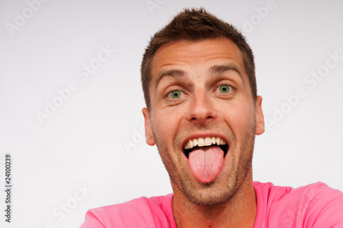 Young attractive man shows his tongue