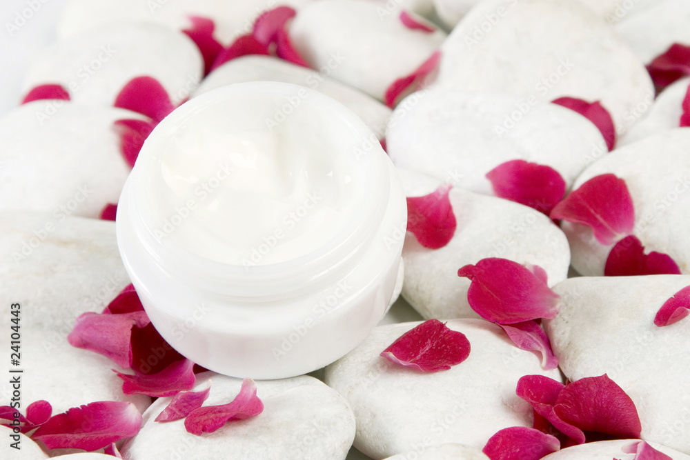 stones and red rose petals background for beauty cream