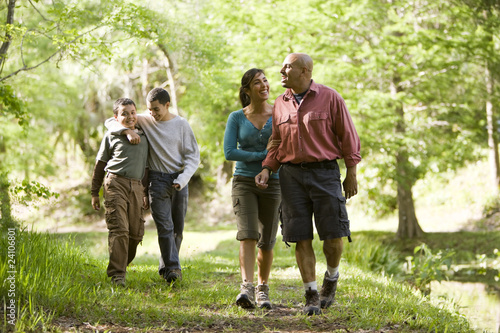 Hispanic family walking along trail in park