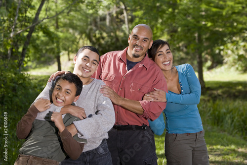 Portrait of Hispanic family with two boys outdoors