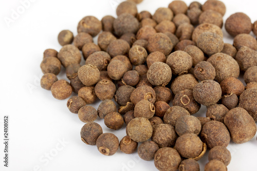 Detail shot of a pile of black peppercorns. All isolated