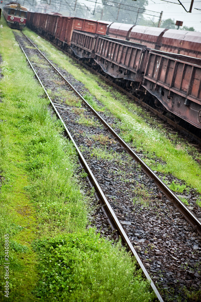 Cargo wagons in the train station during rain Cargo wagons in the train station during rain