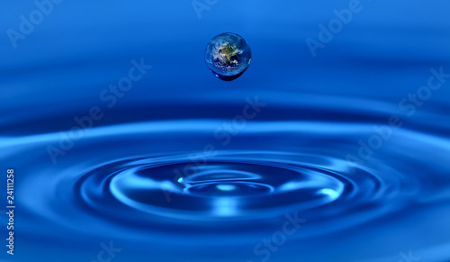 Earth within a water drop. Ecosystem concept.