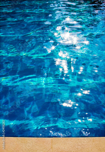 Detail of a swimming pool blue water in summer time