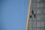 workers cleaning the skyscraper in the city