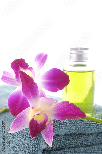 bottles of essential oil with .orchid on blue towel