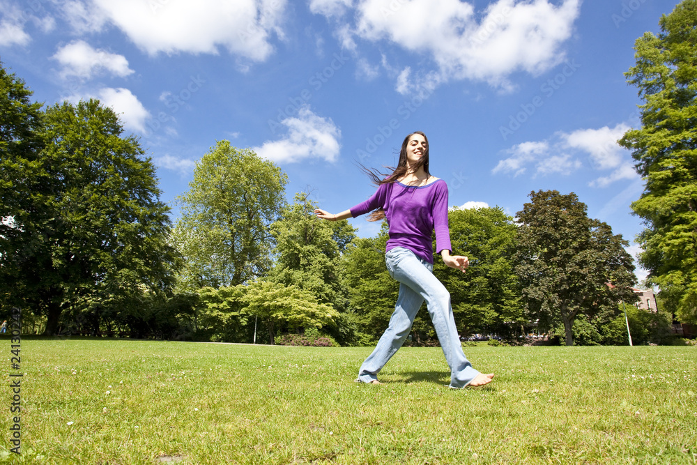 young girl dancing happy in a park young girl dancing happy in a park