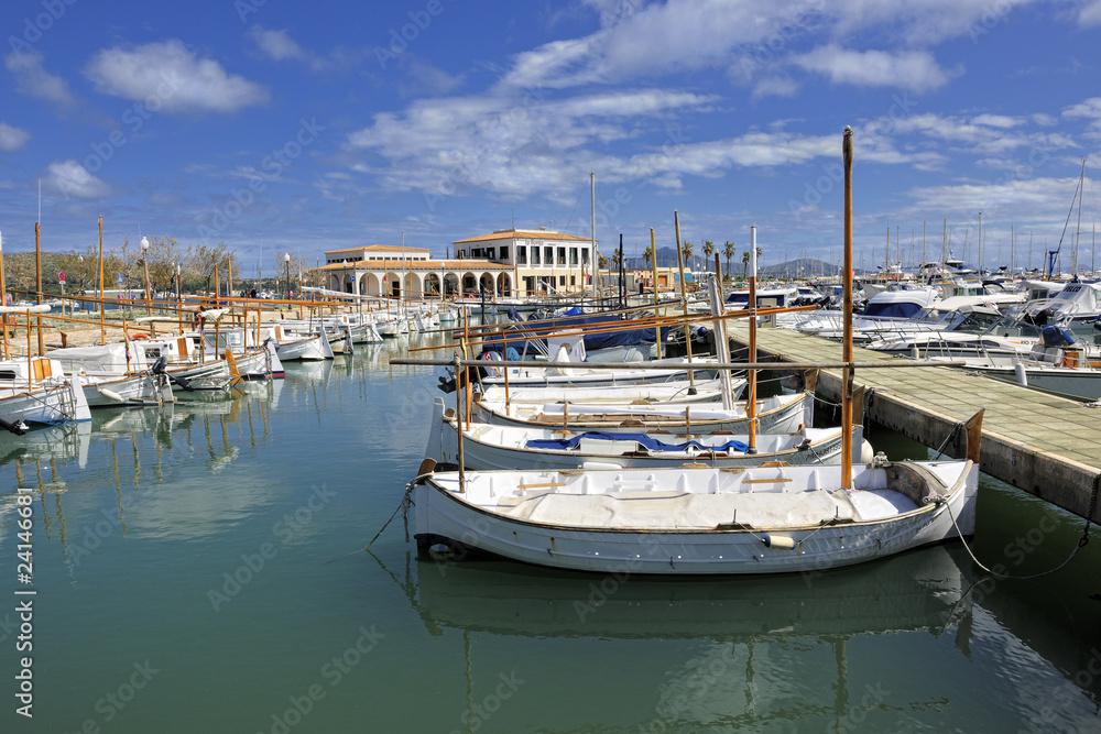 Dinghies and cruisers moored at marina of Port de Pollenca