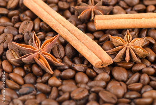 Cinnamon sticks and anise stars on coffee beans