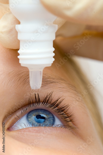 Oculist applying pipette for patients