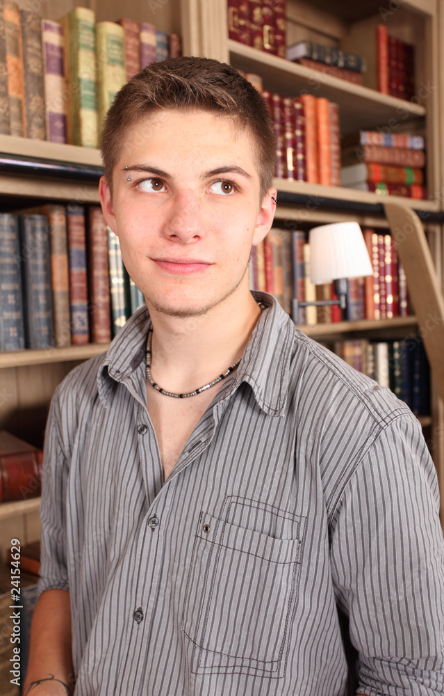 young student dreaming in front of a book shelf young student dreaming in front of a book shelf