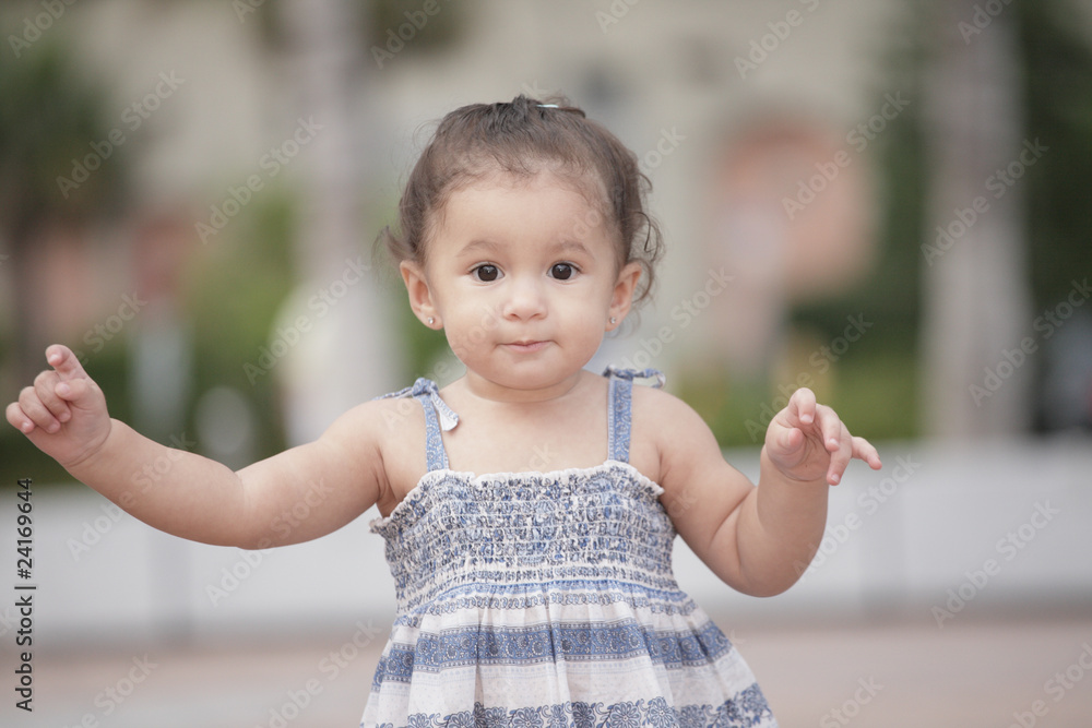 Playful toddler girl in the park Playful toddler girl in the park