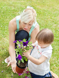 Caucasian Mother showing her daughter a purple flower