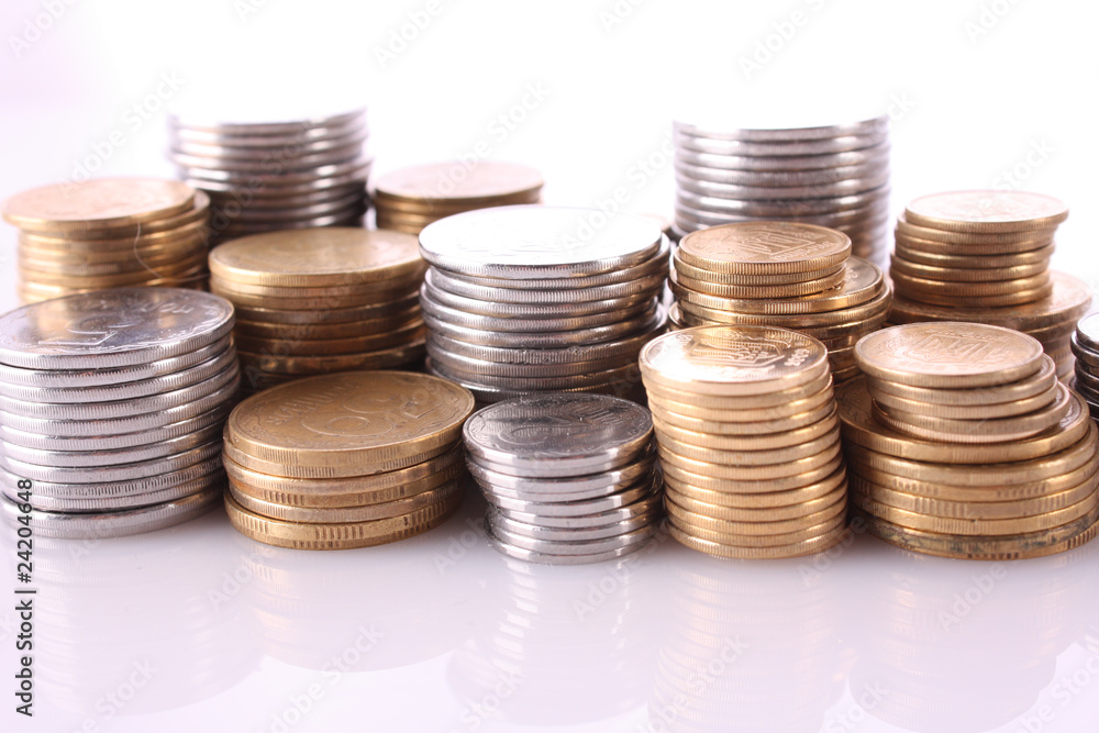 Many coins in column isolated on white Many coins in column isolated on white