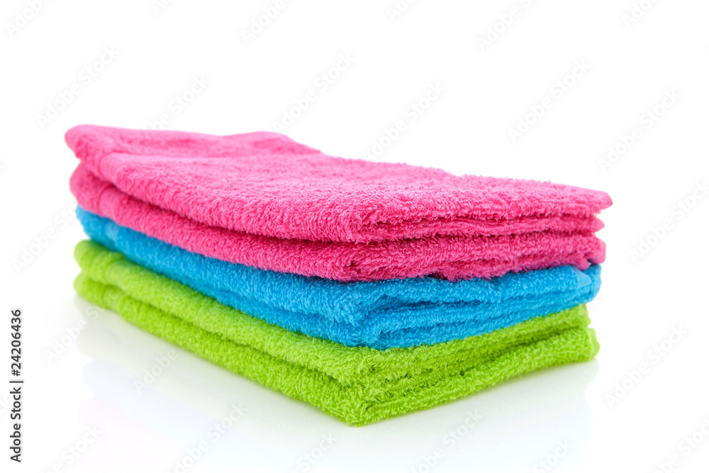 stack of colorful towels over white background stack of colorful towels over white background