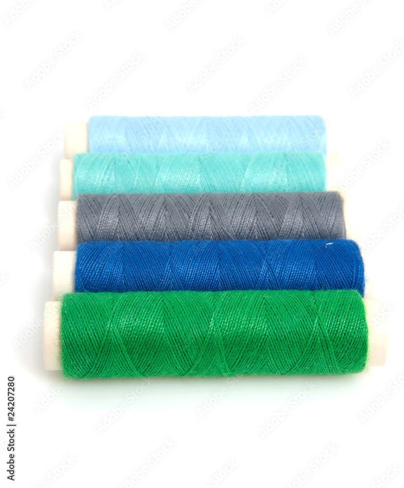 blue and green sewing gear over white background blue and green sewing gear over white background