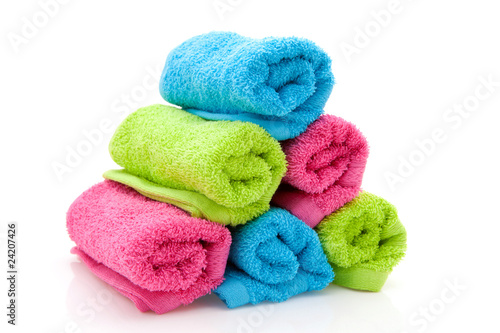 stack of colorful towels over white background © Sandra van der Steen