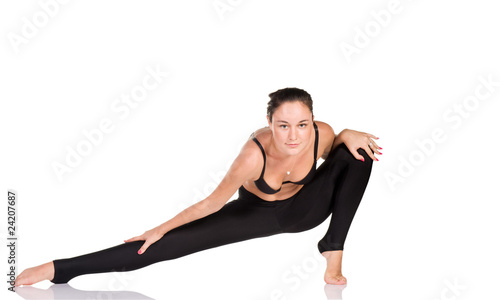 Young woman gymnast exercising isolated on white