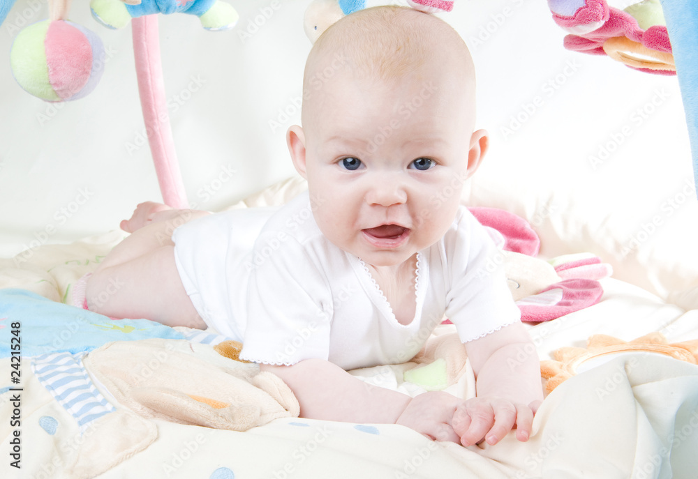 baby girl lying down on playing mat baby girl lying down on playing mat