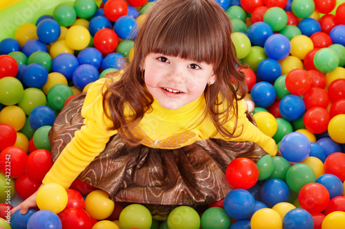 Child in group colourful ball.