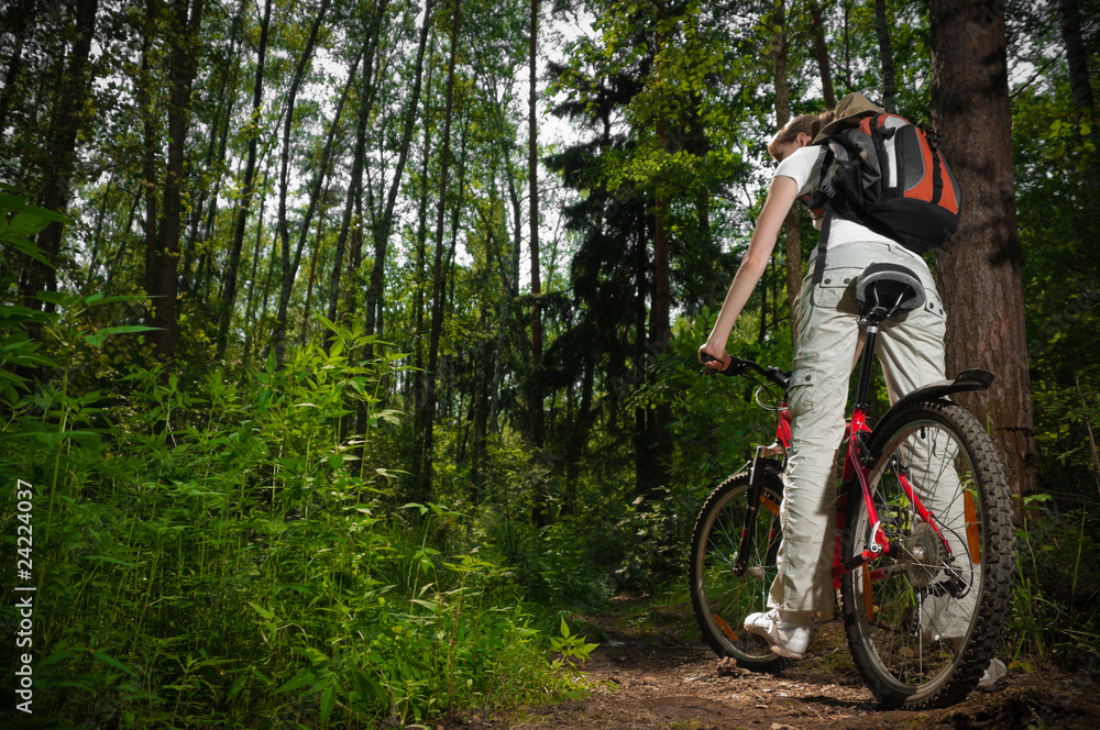 young woman with bicycle in forest young woman with bicycle in forest