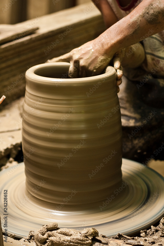 potter's wheel and hands of craftsman hold a jug potter's wheel and hands of craftsman hold a jug