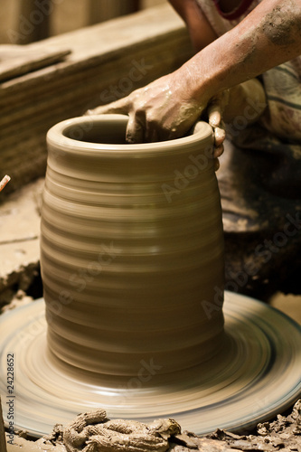 potter's wheel and hands of craftsman hold a jug © tofudevil